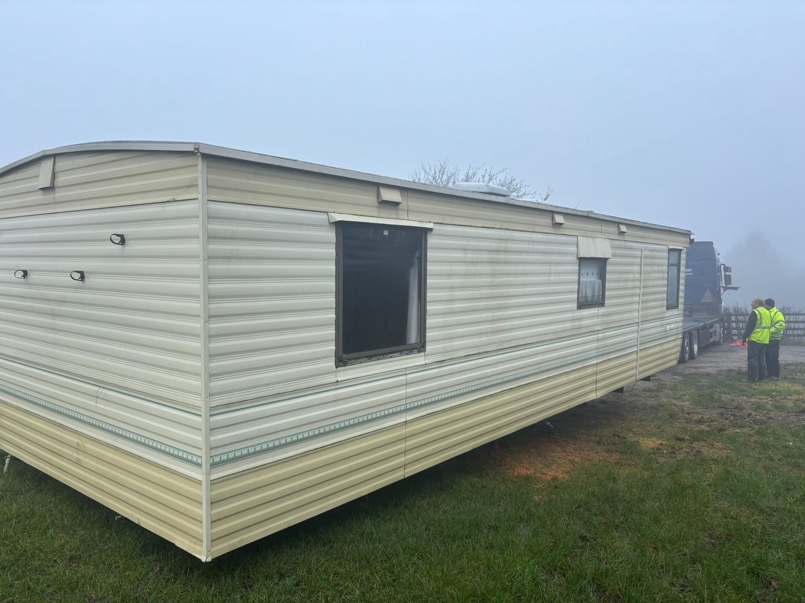 Older static caravan removed from its site awaiting transport