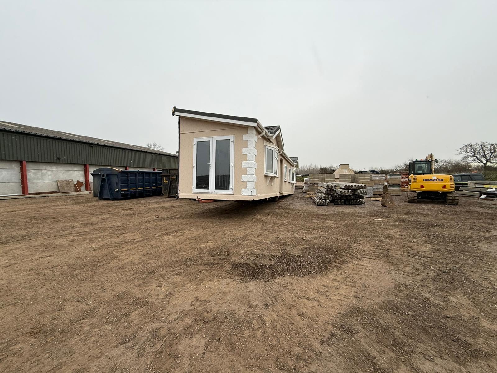 Park home with bay windows positioned on its new site