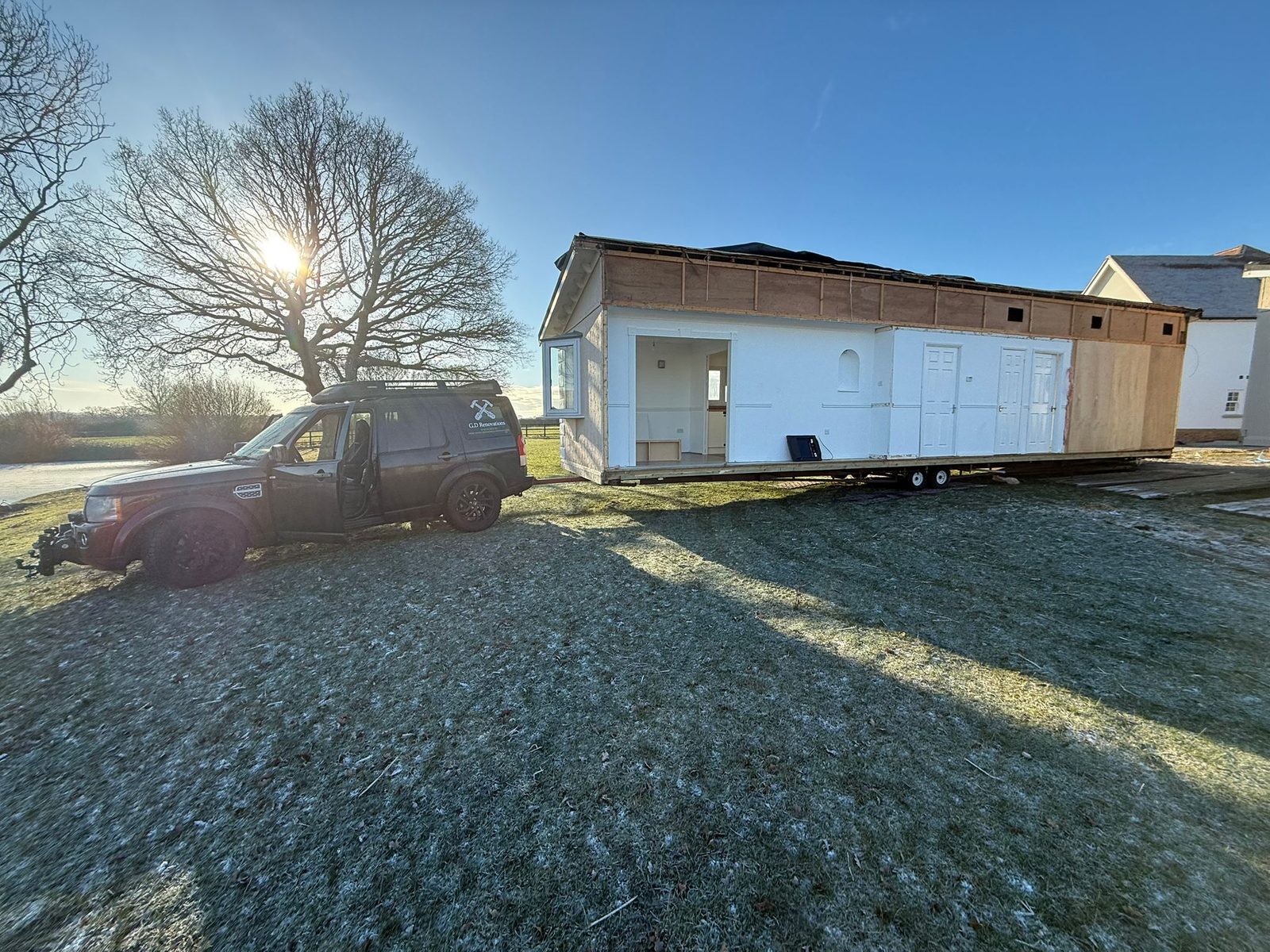 Park home loaded on a transport trailer at sunrise ready for delivery